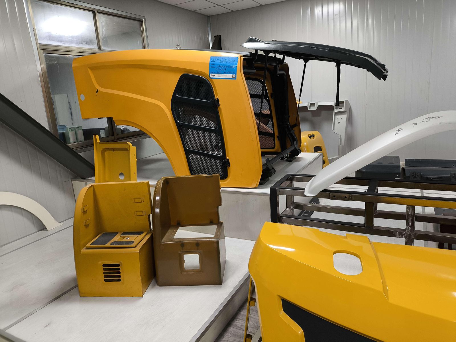 Yellow painted PDCPD covers and hoods for construction equipment